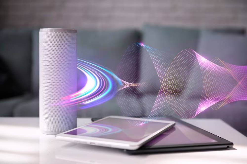A smart speaker emits colorful sound waves above a tablet, symbolizing audio technology in a modern home setting.